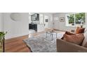 Open living space showcasing hardwood floors, an airy layout, and views to kitchen and front entrance at 3344 W 33Rd Ave, Denver, CO 80211