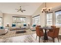 Staged living room with vaulted ceiling, ample windows, and stylish decor at 7498 W Saratoga Pl, Littleton, CO 80123
