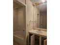 A view of the bathroom with a bathtub, sink, mirror, and tile shower at 805 E 7Th Ave # 8, Denver, CO 80218