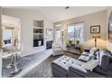 Cozy living room with vaulted ceilings, carpet floors, built-in shelving and fireplace at 8481 W Union Ave # 4-203, Littleton, CO 80123