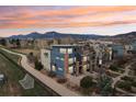 Stunning exterior view of townhome showcasing architectural details, and lush landscaping at sunset with mountain backdrop at 3644 Pinedale St, Boulder, CO 80301
