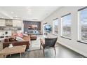 Open concept living room with a comfortable seating area, kitchen in background and bright view from windows at 3644 Pinedale St, Boulder, CO 80301