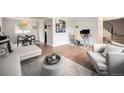 Inviting living space features an open floor plan, modern decor, and an adjacent dining area at 6251 W 74Th Ave, Arvada, CO 80003