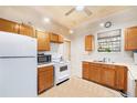 Traditional kitchen featuring wood cabinets, white appliances, and a ceiling fan at 2350 N Ogden St, Denver, CO 80205