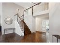 Two-story entryway with hardwood floors and a staircase at 3481 Meadow Creek Pl, Highlands Ranch, CO 80126