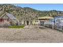 Exterior of a cute home with a carport and a low-maintenance gravel yard at 230 Miner St, Idaho Springs, CO 80452