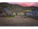 Inviting home exterior with a carport set against a scenic mountain backdrop at dusk at 230 Miner St, Idaho Springs, CO 80452