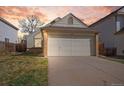 Charming home with a two-car garage, brick accents, and a well-maintained front yard at 12977 W Dorado Pl, Littleton, CO 80127
