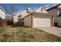 Charming home featuring a two-car garage and well-maintained lawn, perfect for suburban living at 12977 W Dorado Pl, Littleton, CO 80127
