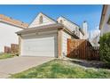 Charming home featuring a two-car garage, fenced yard, and well-maintained landscaping at 12977 W Dorado Pl, Littleton, CO 80127