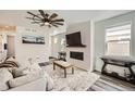 Bright living room boasts modern ceiling fan, fireplace, and stylish decor at 1994 Spencer Ave, Castle Rock, CO 80104