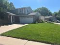 Well maintained two story home, with a beautiful lawn, driveway, and attached two car garage at 5612 S Lansing Ct, Englewood, CO 80111