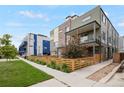 Contemporary townhome showcases a fenced yard, balcony, and street-side appeal within a modern community at 1921 Hooker St, Denver, CO 80204