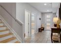 Welcoming foyer features tile flooring, wooden stairs, and a stylish console table, blending warmth and modernity at 1921 Hooker St, Denver, CO 80204