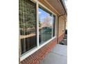 Exterior view of a brick home showcasing a window reflecting the landscape at 1445 S Eaton St, Lakewood, CO 80232