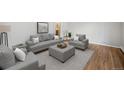 Staged living room featuring neutral furniture and beautiful hardwood floors at 1445 S Eaton St, Lakewood, CO 80232