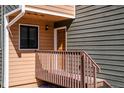Close-up of the home's entrance featuring a covered porch, wooden railing, and a welcoming doorway at 2885 Springdale Ln, Boulder, CO 80303