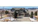 Beautiful two-story home with stone accents, three-car garage, and mountain views at 7603 Yule Ct, Arvada, CO 80007