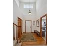 Inviting foyer with hardwood floors, high ceilings, and staircase at 7603 Yule Ct, Arvada, CO 80007