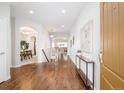 Inviting home foyer featuring hardwood floors, arched doorways, and elegant decor at 19377 E Radcliff Pl, Aurora, CO 80015