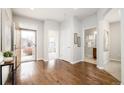 Open concept home entrance with gleaming hardwood floors and neutral paint at 19377 E Radcliff Pl, Aurora, CO 80015