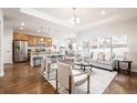 Bright and airy living room with open floor plan to kitchen and dining area at 19377 E Radcliff Pl, Aurora, CO 80015