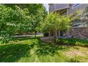 Well-maintained lawn complements the building's stone accents at 8427 S Hoyt Way # 107, Littleton, CO 80128