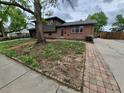 Charming brick home with a well-maintained lawn and inviting walkway at 902 S Potomac Way, Aurora, CO 80012