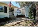 A welcoming exterior featuring stone landscaping, neat shrubbery, and a charming American flag at 4675 S Yosemite St # 205, Denver, CO 80237