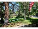 An idyllic front yard scene featuring lush greenery, mature trees, and a glimpse of neighborhood charm at 4675 S Yosemite St # 205, Denver, CO 80237