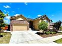 Inviting home with a three-car garage, brick accents, and a landscaped yard under a bright blue sky at 425 W 128Th Dr, Westminster, CO 80234