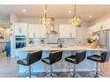 Modern kitchen with white cabinets, stainless steel appliances, and an island at 425 W 128Th Dr, Westminster, CO 80234