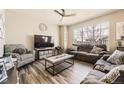 Comfortable living room featuring large window, neutral tones, and cozy seating at 11769 Lovegrass Dr, Parker, CO 80138