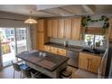Bright kitchen with stainless steel appliances, center island, and light wood cabinets at 3725 S Nepal St, Aurora, CO 80013