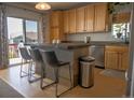 Bright kitchen with stainless steel appliances, center island, and light wood cabinets at 3725 S Nepal St, Aurora, CO 80013