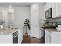 Modern kitchen with white cabinets, stainless steel appliances, and a functional layout at 3548 Swabuck Pl, Castle Rock, CO 80109