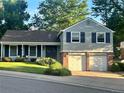 Charming two-story home features a well-manicured front yard and an attached two-car garage at 6918 E Easter Pl, Centennial, CO 80112