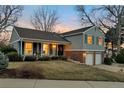 Charming two-story home features an attached two-car garage, covered porch, and manicured lawn at 6918 E Easter Pl, Centennial, CO 80112