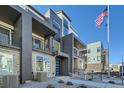 Contemporary townhome showcasing modern architecture with private balconies and well-maintained landscaping at 16555 Peak Way, Broomfield, CO 80023