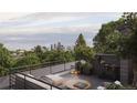 A rooftop deck offering city views, featuring an outdoor seating area and a grill at 4815 W 10Th Ave, Denver, CO 80204