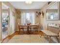 Bright dining area featuring a wooden table with seating for four, and lots of natural light at 12023 W Virginia Ave, Lakewood, CO 80228