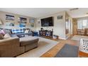 Cozy living room with hardwood floors, a comfortable sectional sofa, and natural light at 12023 W Virginia Ave, Lakewood, CO 80228
