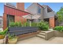 Charming exterior view of a multi-level home with gray siding, brick accents, and a garden area at 780 Walnut St # A, Boulder, CO 80302