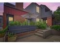 Charming exterior view of a multi-level home with gray siding, brick accents, and a garden area at 780 Walnut St # A, Boulder, CO 80302