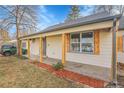 Updated home exterior with wood accents and landscaping at 3540 E Jewell Ave, Denver, CO 80210