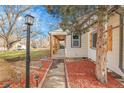 Brick pathway leading to the side entrance of the home at 3540 E Jewell Ave, Denver, CO 80210