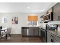 Bright kitchen with stainless steel appliances, gray cabinets, and a subway tile backsplash perfect for cooking at 17767 E 54Th Ave, Denver, CO 80249