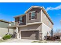 Charming two-story home featuring a two-car garage, complemented by neutral siding and stone accents at 23757 Eagle Bend Ln, Parker, CO 80138
