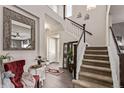 Spacious foyer with hardwood floors, staircase, and stylish decor at 23757 Eagle Bend Ln, Parker, CO 80138