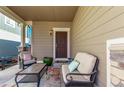 Inviting covered front porch with comfortable seating, perfect for relaxing outdoors at 23757 Eagle Bend Ln, Parker, CO 80138